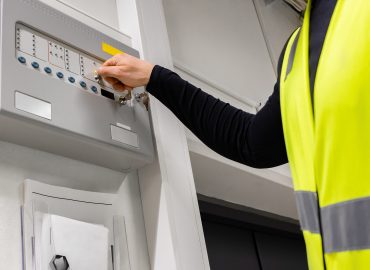 Electrician Opening Fire Panel In Server Room