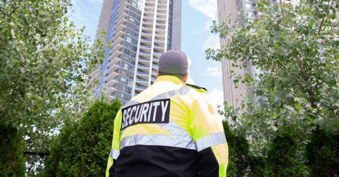 Security guard in uniform patrolling a residential area.